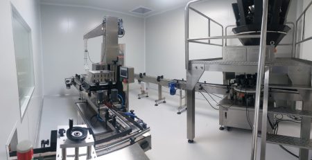 Stainless steel machinery used for large-scale gummy supplement production.
